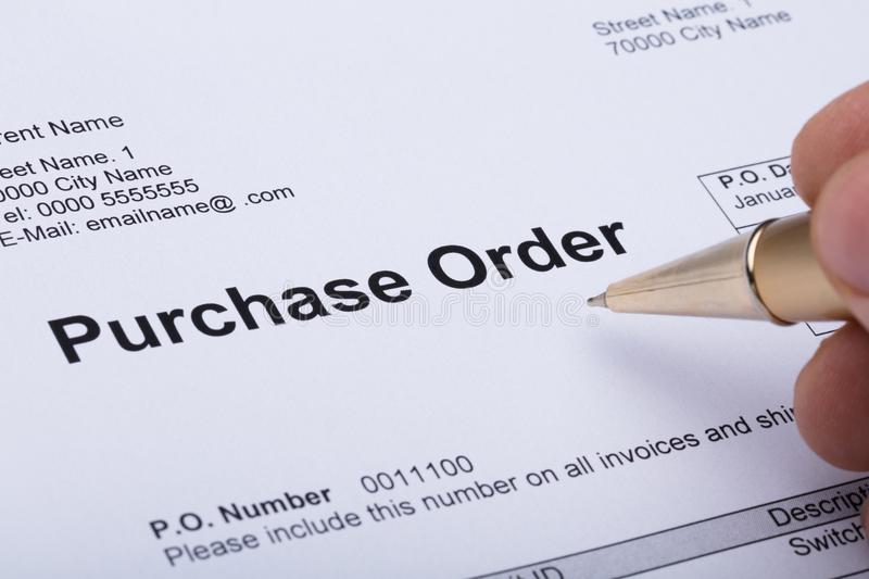 person-hand-filling-purchase-order-form-close-up-124740129